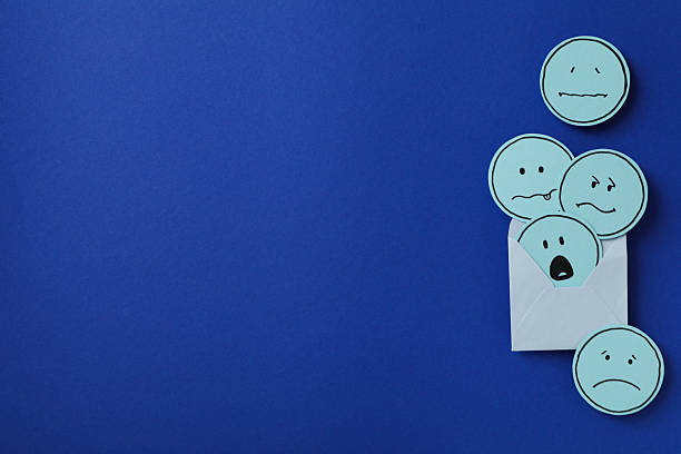 istock Envelope with sad emoji on blue background, space for text 2209992656