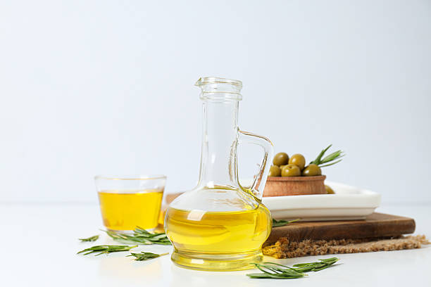istock Olive oil and olives on white background 2209995891