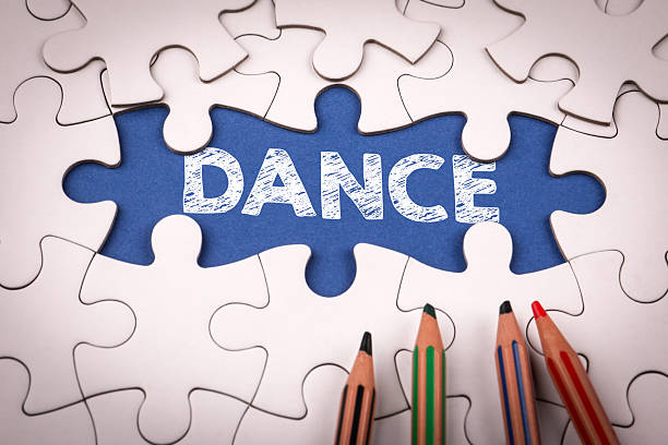 istock DANCE. White puzzle pieces and colored pencils 2210007872