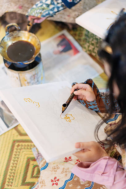 istock Young Woman Hands-On Batik Workshop with Hot Wax and Canting Tools 2210009174