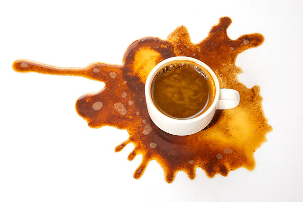 istock Rich coffee spills from a white cup, spreading across a pristine surface in a striking brown pattern, ideal for food and lifestyle themes 2210011048