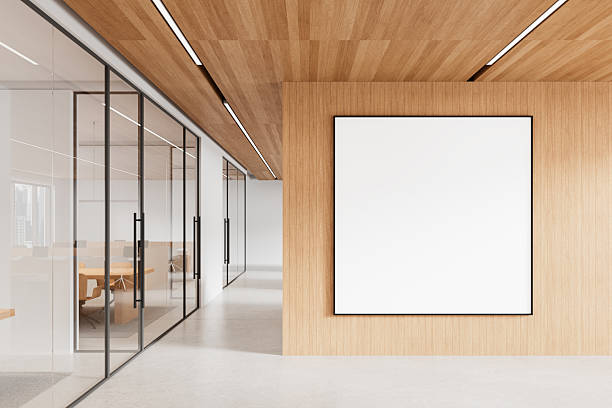 istock Modern office interior with blank poster on wooden wall. 3D Rendering 2210015085