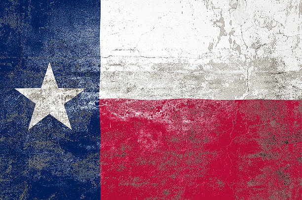 istock Texas State Flag. Dirty Texas state flag on the wall. 2210016717