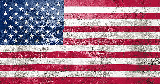 istock US State Flag. Dirty American state flag on the wall. 2210017571