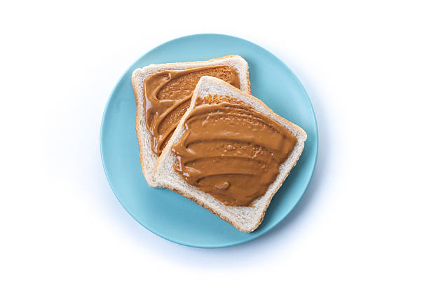 Bread toast with peanut butter cream isolated on white background