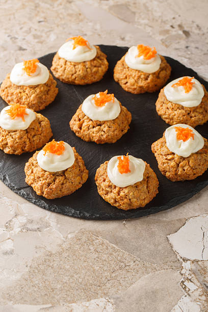 istock Cream Cheese Carrot Cake Cookies close up on the plate. Vertical 2210020806