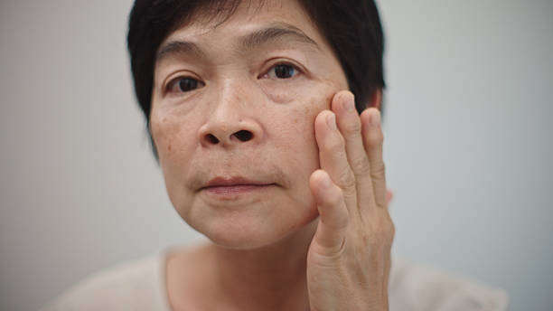istock Mature woman looking her skin. 2210020809