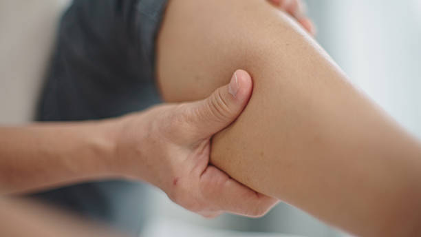 istock Hands massaging sore leg at home. 2210020993