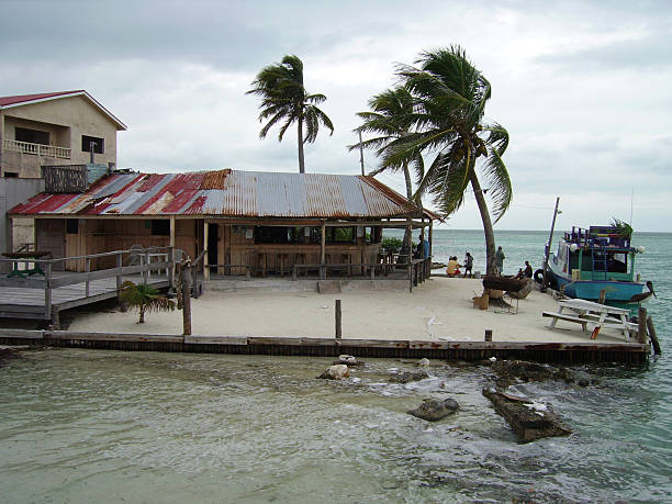 Cabana at the split in Caye Caulker, a beautiful tropical island in the Belize cays. People watching the sea on the stormy day.