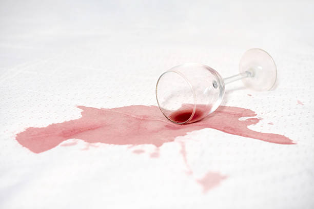 istock Red wine glass spill on white fabric surface 2210023878