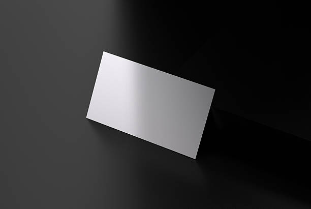 istock Blank business card on black background with soft shadow 2210026000