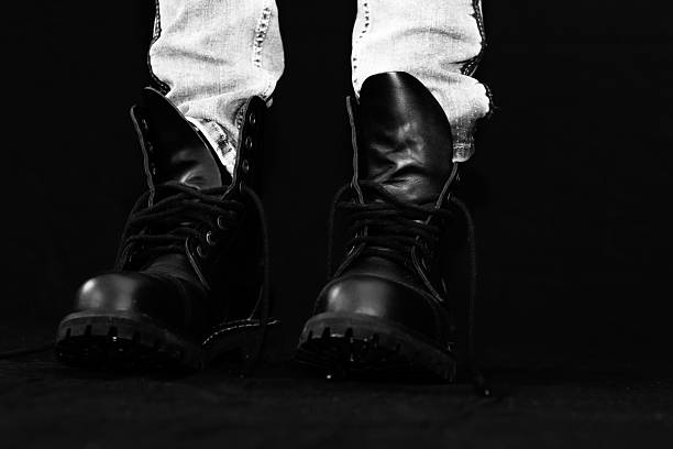 istock Stylish Boots on Black Background in black and white 2210026556