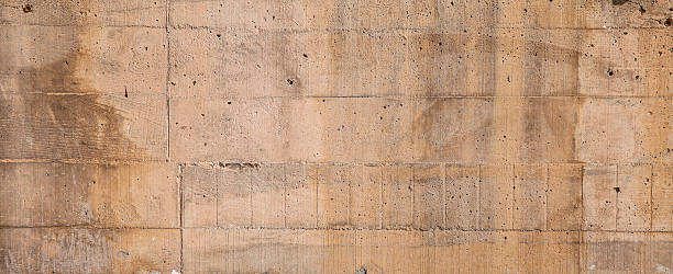 A textured concrete surface showcasing natural patterns, weathered details, and neutral beige tones suitable for backgrounds, textures, or industrial design elements.