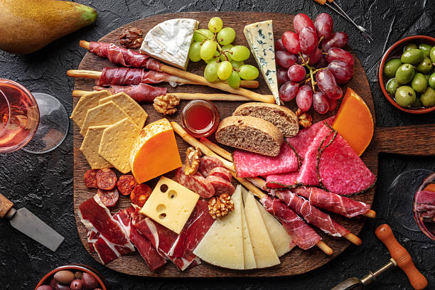 istock Antipasti or tapas. Charcuterie and cheese board with wine, overhead 2210027858