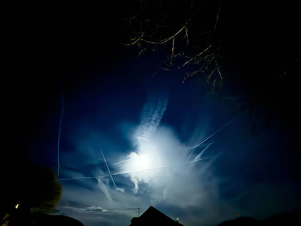 istock Night sky with bright moon and dramatic clouds illuminated in silhouette 2210029914