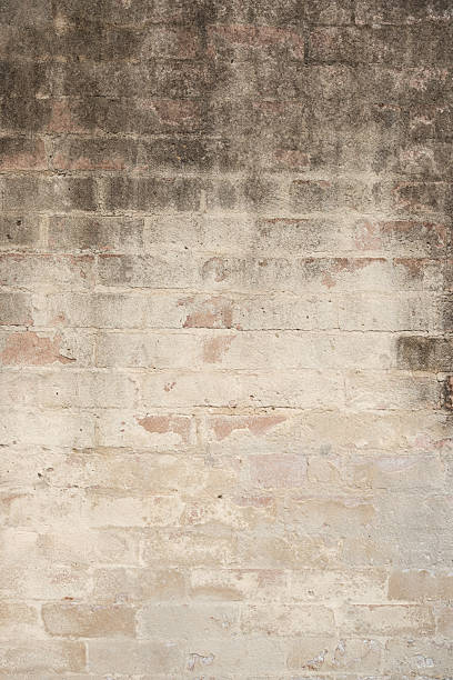 istock Dirty stained faded brick wall background 2210030855