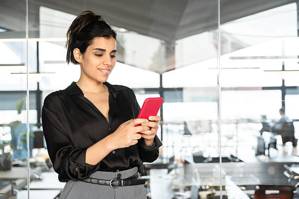 istock Young Indian or arabian business woman ceo manager using cell phone mobile application. Smiling Latin Hispanic businesswoman holding smartphone for finance work chat online in office. Copy space 2210031458