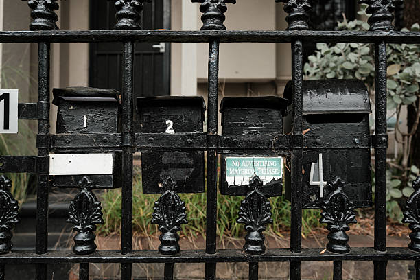 istock Four black mailboxes on a metal fence 2210031664