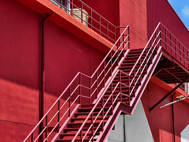 istock A set of stairs ascending a large red wall 2210034970