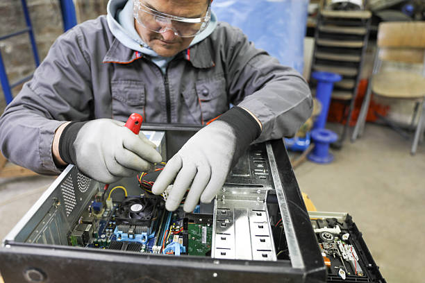 istock Senior technician repairing and cleaning a computer. 2210038784
