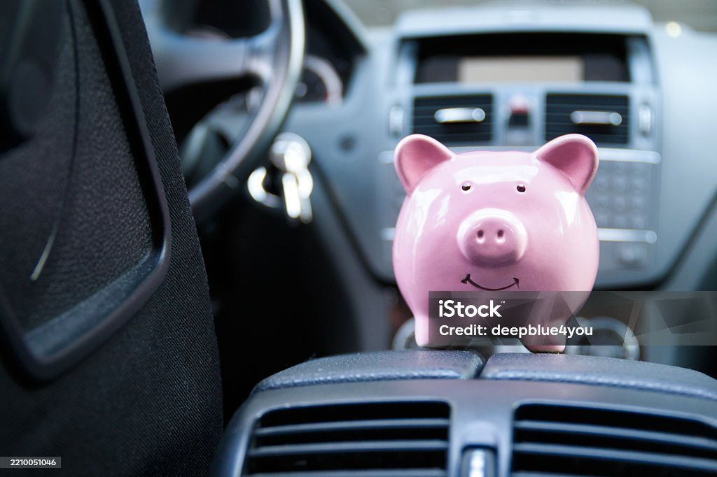Piggy bank in a car – symbolic image for vehicle purchase, insurance or driving costs Car Insurance Stock Photo Piggy bank in a car – symbolic image for vehicle purchase, insurance or driving costs Car Insurance Stock Photo