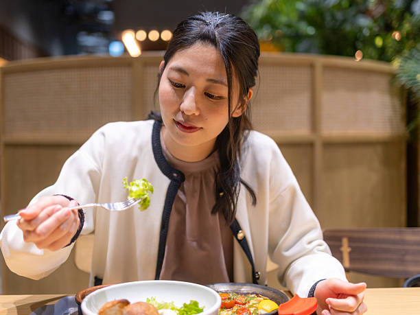 istock Business woman having dinner in restaurant 2210053466