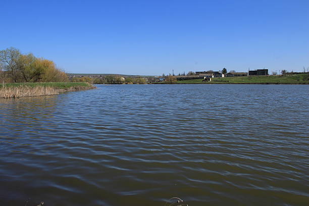 A large body of water with a sign on it. Sky. Outdoor. Water. Lake. River