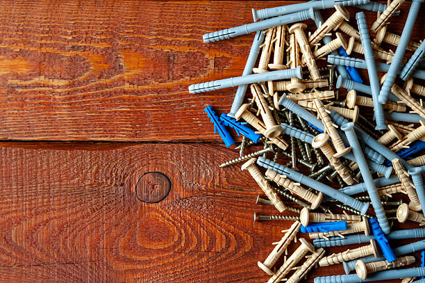 istock Screws and plastic dowels on a wooden background 2210056640