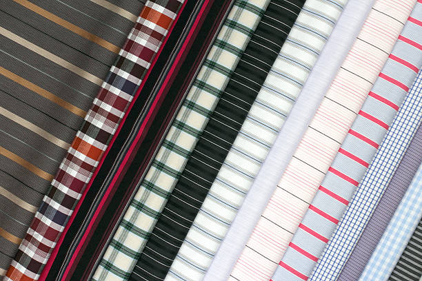 Colorful fabric layers showcasing checkered and striped styles in various tones, ideal for fashion design or sewing projects.