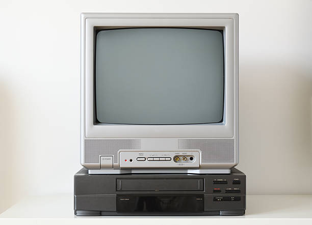istock Vintage television and VHS player on a white shelf 2210057667