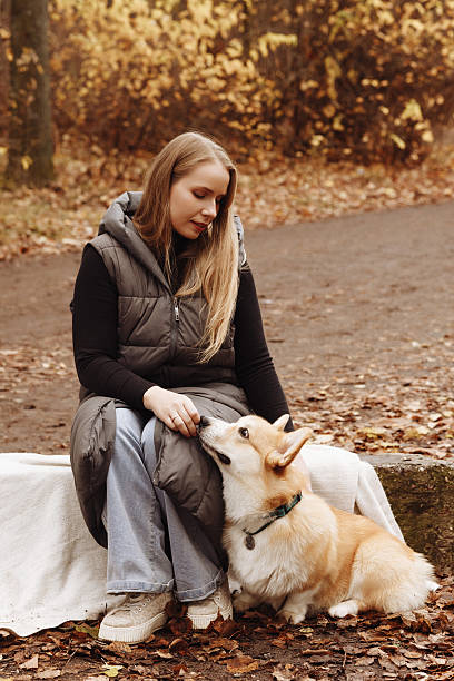 istock Woman with Corgi in Autumn Park 2210059257