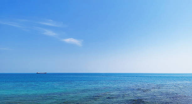 istock A cargo ship is floating alone in the middle of the sea. 2210060394