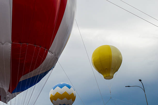 Hot air balloons are above with a cloudy sky background
