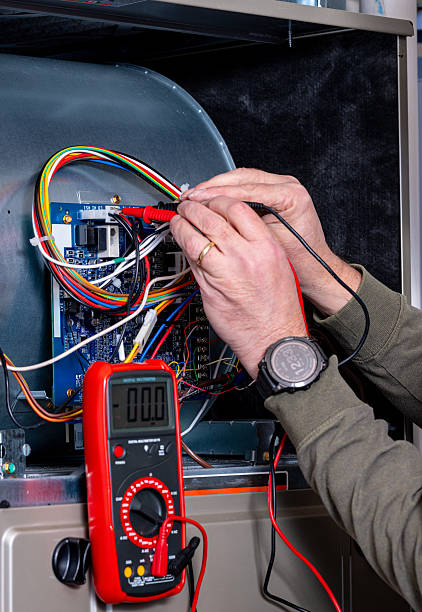 istock Master electrician works on a furnace 2210068522