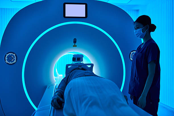 istock Female Nurse Operating MRI Scan Machine at MRI-scanner Room 2210069424