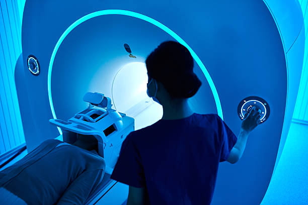 istock Female Nurse Operating MRI Scan Machine at MRI-scanner Room 2210069549