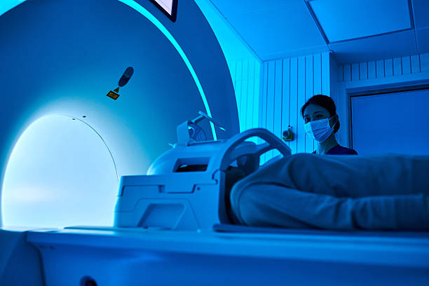 istock Female Nurse Operating MRI Scan Machine at MRI-scanner Room 2210069550