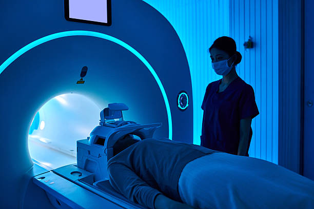 istock Female Nurse Operating MRI Scan Machine at MRI-scanner Room 2210069579