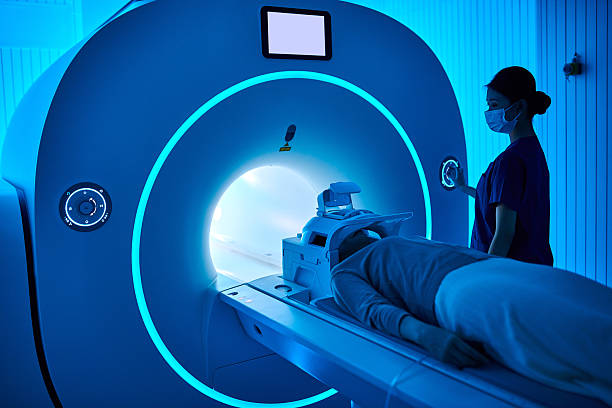 istock Female Nurse Operating MRI Scan Machine at MRI-scanner Room 2210069746
