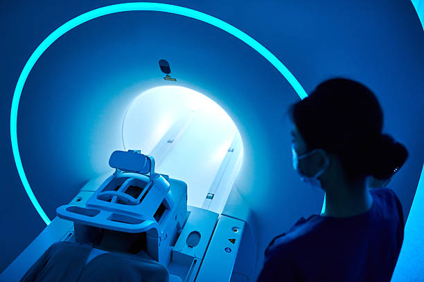 istock Female Nurse Operating MRI Scan Machine at MRI-scanner Room 2210069877