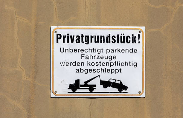 Sign: Unauthorized parking will be towed away at your expense.