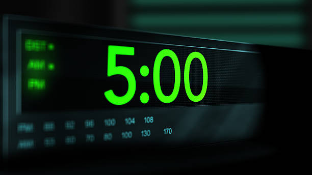 istock Camera pans across old digital clock as time arrives at 5 AM - Green Version 2210075085