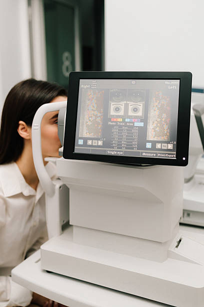 istock Girl undergoes an OCT eye exam using advanced optical coherence tomography equipment. The high-resolution display shows retinal scans, assisting in early diagnosis of eye diseases. 2210075422