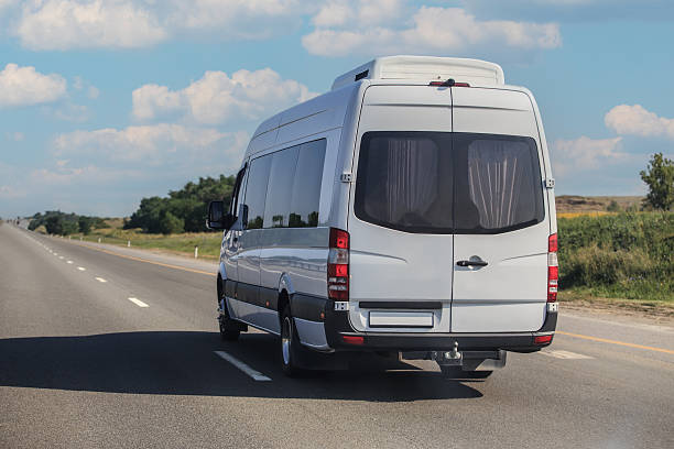 istock Minibus moves along a country road 2210078014