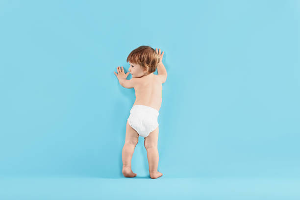 istock Cute little child in diaper on light blue background 2210080273
