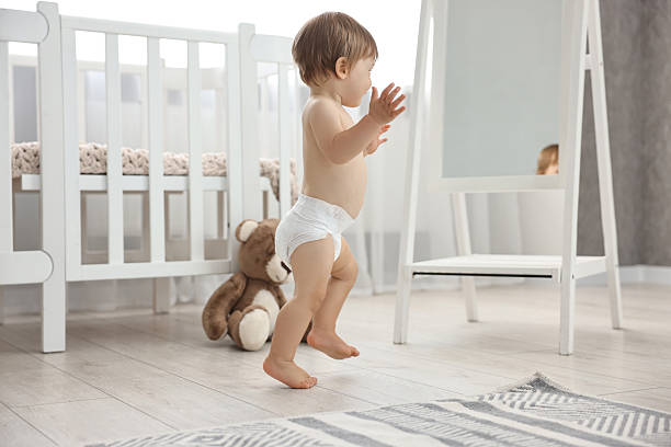 istock Cute little child in diaper at home 2210080323