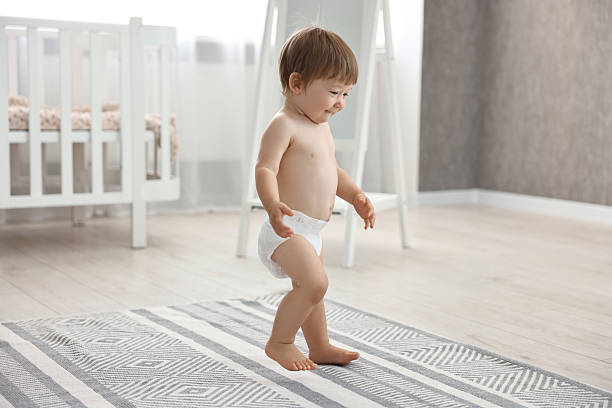 istock Cute little child in diaper at home 2210080351