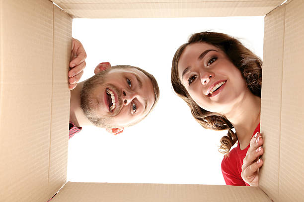 istock Young man and woman looking inside the box 2210080632