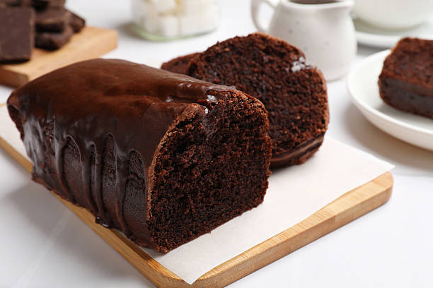istock Delicious chocolate sponge cake on white tiled table, closeup 2210080786