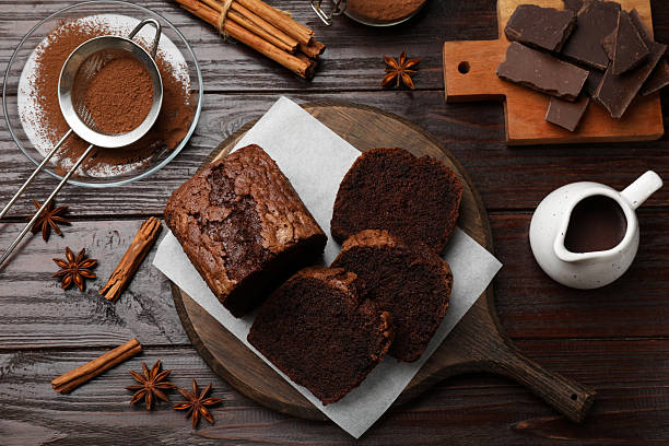istock Delicious cut chocolate sponge cake and ingredients on wooden table, flat lay 2210080798